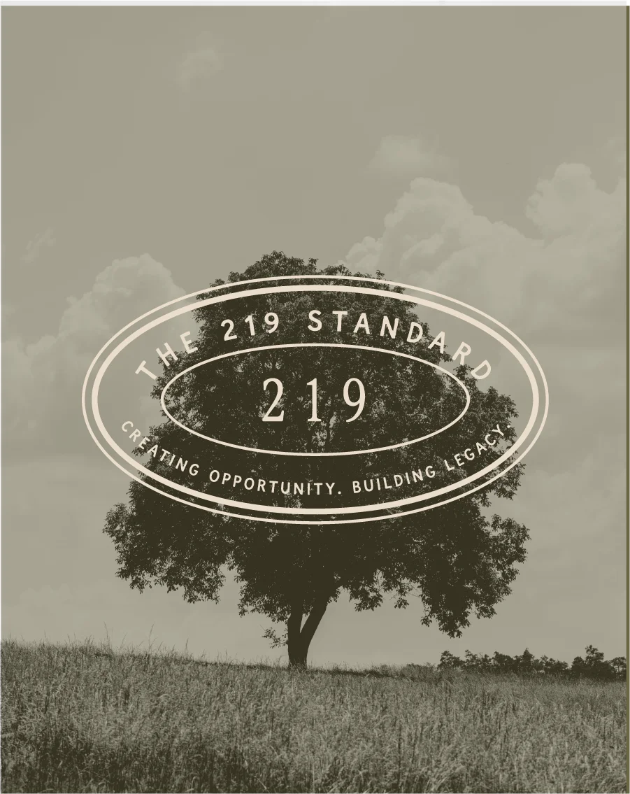 A lone tree in an open field with The 219 Standard submark